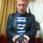 Former prisoner of conscience Bassem Tamimi holds plastic and rubber-coated bullets fired by Israeli forces.