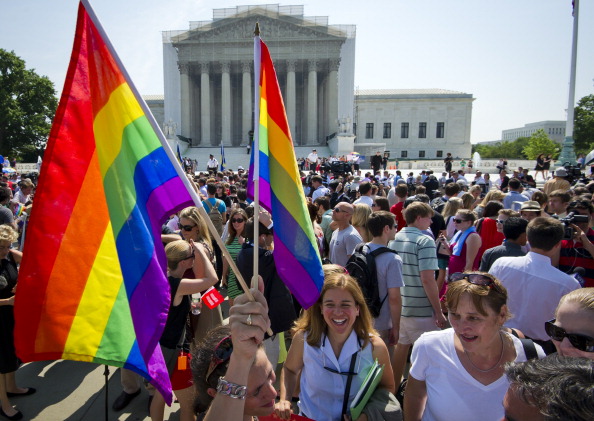 Gay rights activists gather outside the U.S. Supreme Court building in Washington, D.C. Today, the Supreme Court struck down a controversial federal law that defines marriage as a union between a man and a woman, in a major victory for supporters of same-sex marriage (Photo Credit: Mladen Antonov/AFP/Getty Images).