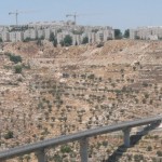 An 'Israeli only' by-pass road that links Israeli settlements in the occupied West Bank, sitting below an Israeli settlement outside of Jerusalem (Photo Credit:  Edith Garwood).