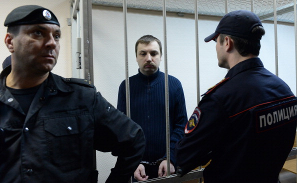 Mikhail Kosenko stands in a defendant cage in a court in Moscow (Photo Credit: Vasily Maximov/AFP/Getty Images).