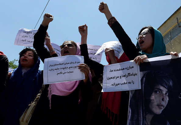 Afghan university students and independent civil society activists take part in a demonstration in support of passing the Elimination of Violence against Women law in front of Parliament in Kabul (Photo Credit: Shah Marai/AFP/Getty Images).