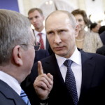 Russian President Vladimir Putin talks with International Olympic Committee President Thomas Bach at a welcoming event ahead of the 2014 Winter Olympics (Photo Credit: David Goldman-Pool/Getty Images).