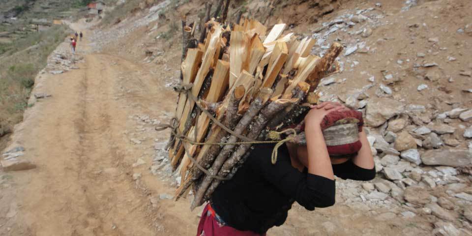 A woman carries wood in Mugu district, Nepal, May 2013 (Photo Credit: Amnesty International).