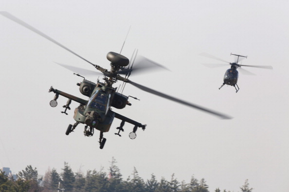 In 2013, Amnesty International documented the use of attack helicopters by Egyptian security forces for surveillance against crowds and protesters. Now, the Obama administration is selling 10 Apache military helicopters to the country (Photo Credit: Ken Ishii/Getty Images). 
