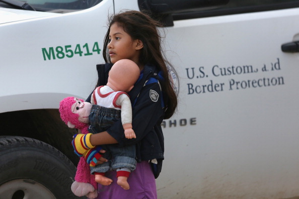 Salvadorian immigrant Stefany Marjorie, 8, holds her doll Rodrigo while going home on July 24, 2014 in Mission, Texas. Tens of thousands of immigrant families and unaccompanied minors from Central America have crossed illegally into the United States this year, causing a humanitarian crisis. (Photo by John Moore/Getty Images)