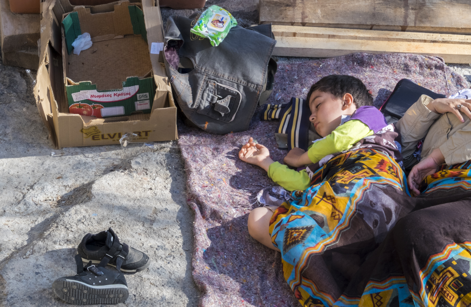 Child sleeping in a makeshift outdoor camp on the Greek island of Lesvos, 2015. © Michael S Honegger