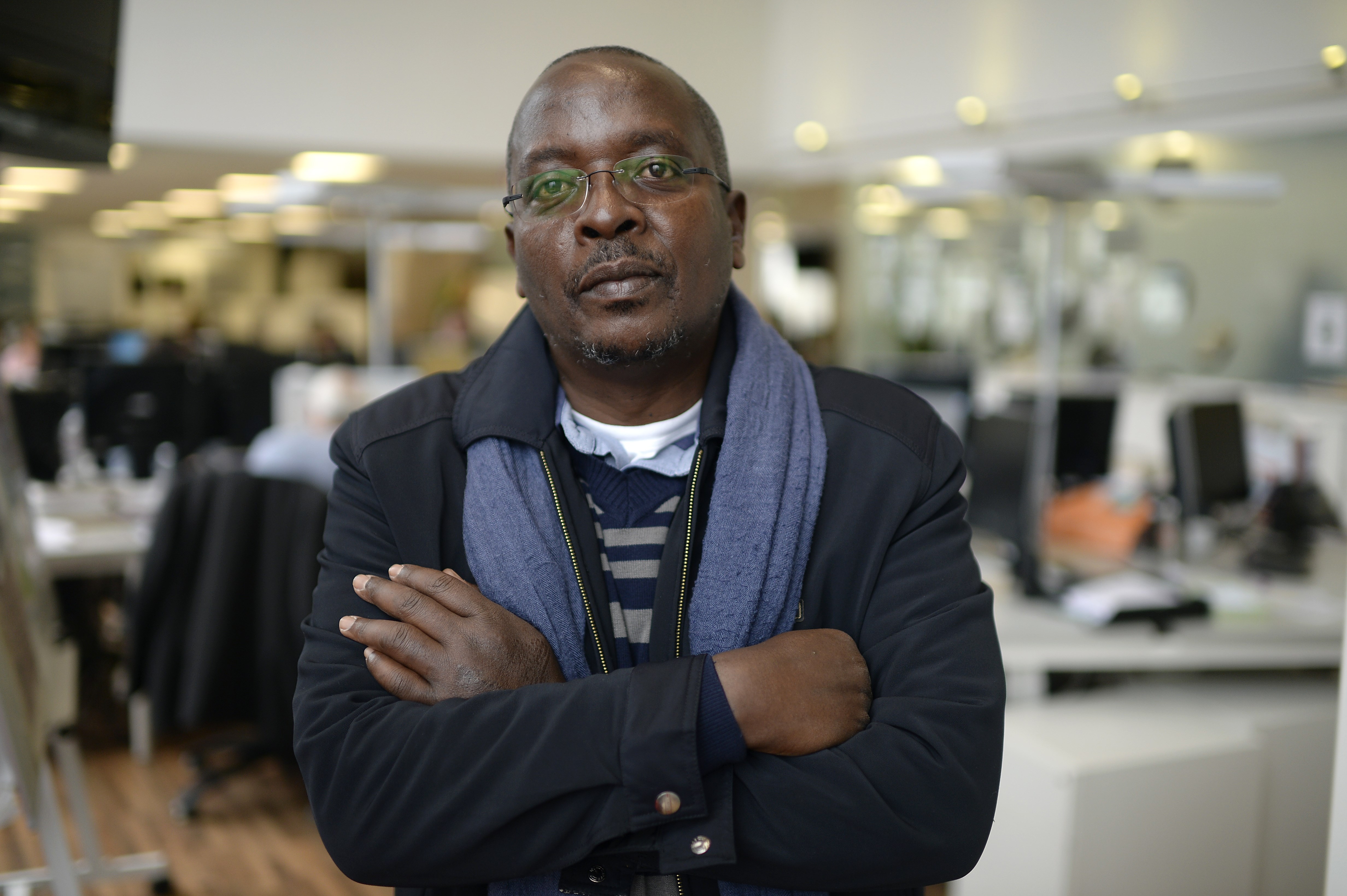 Burundi-based AFP journalist Esdras Ndikumana poses at the Agence France-Presse (AFP) headquarters in Paris on October 19, 2015. Ndikumana, 54, was taking pictures at the scene of the assassination of a top general in the capital Bujumbura on August 2, when he was arrested by members of the National Intelligence Service (SNR). He was held for around two hours, during which he was subjected to severe beatings on his back, legs and the soles of his feet. AFP PHOTO / MIGUEL MEDINA        (Photo credit should read MIGUEL MEDINA/AFP/Getty Images)