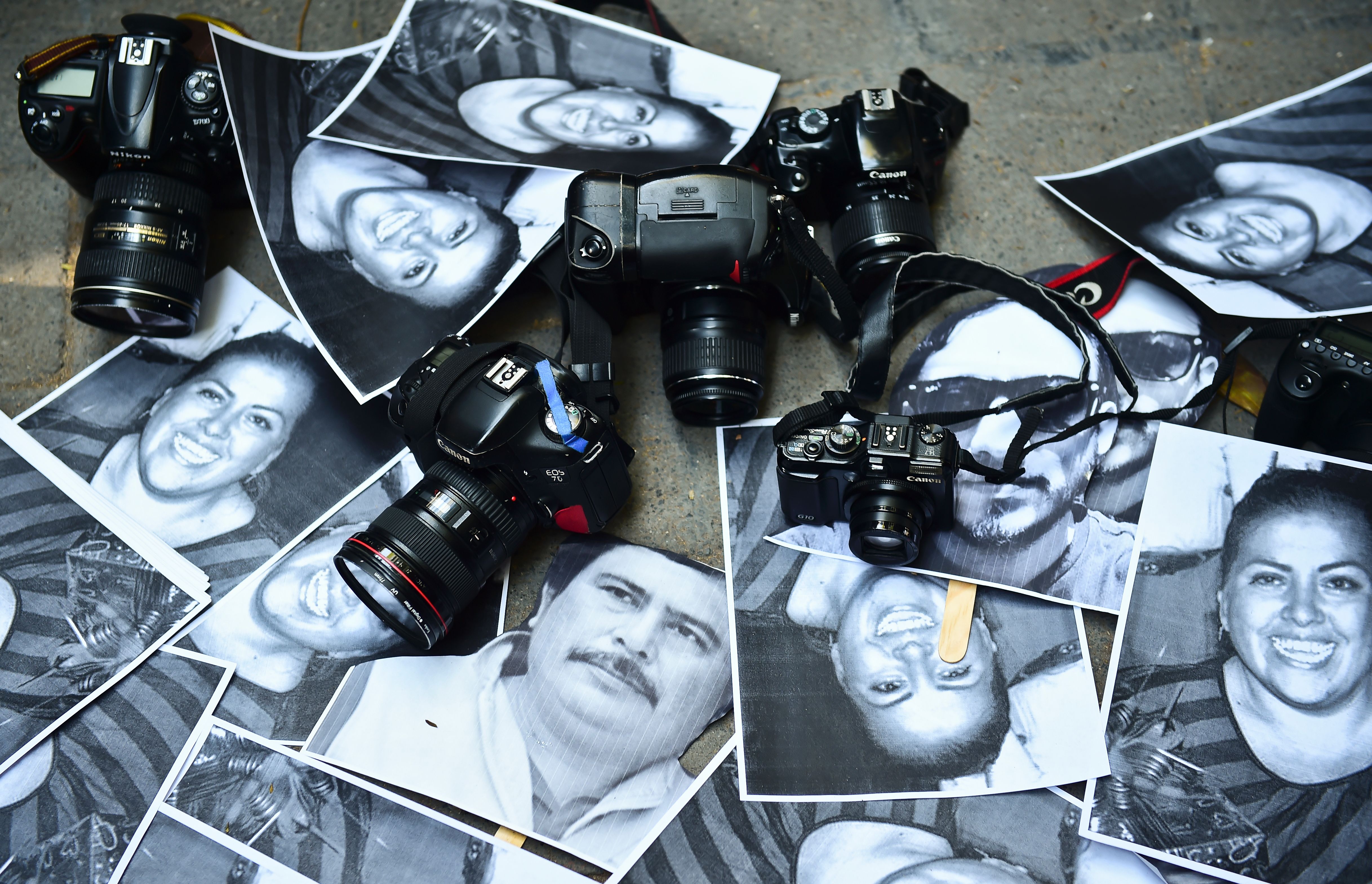 View of photos of killed journalists and cameras outside the Veracruz state representation office during a journalists protest in Mexico City on February 11, 2016. Mexican journalist Anabel Flores Salazar's funeral took place Wednesday after she was found killed at a road after being kidnapped Monday in Veracruz state, one of the most dangerous for journalists.  AFP PHOTO/RONALDO SCHEMIDT / AFP / RONALDO SCHEMIDT        (Photo credit should read RONALDO SCHEMIDT/AFP/Getty Images)