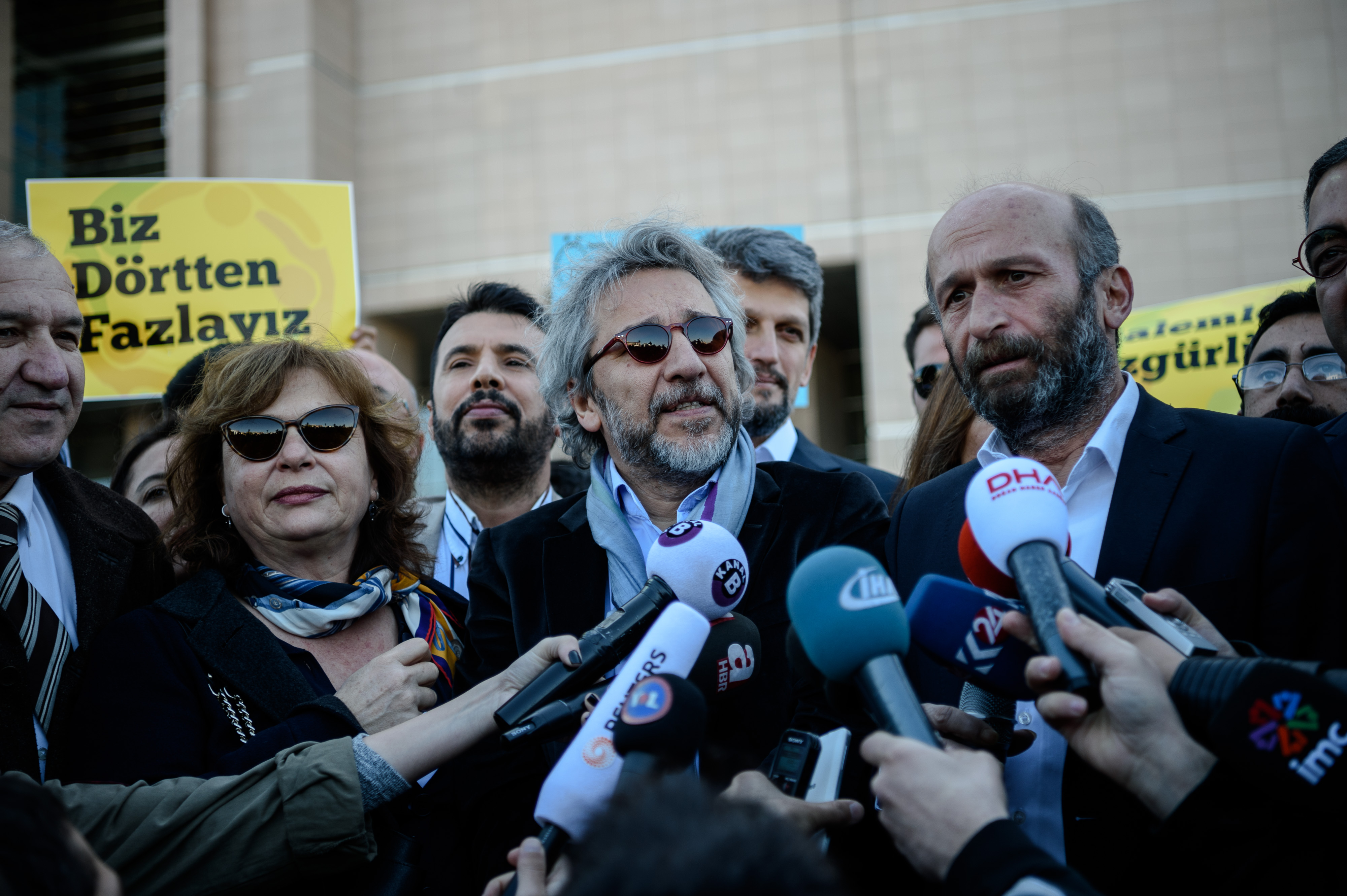 Editor-in-chief of Turkish newspaper Cumhuriyet daily Can Dundar (C) and the newspaper bureau chief in Ankara Erdem Gul (R) arrive to the Istanbul courthouse for their trial on April 22, 2016 in istanbul.   Cumhuriyet daily's editor-in-chief Can Dundar and Ankara bureau chief Erdem Gul face possible life terms on spying charges over a news report accusing President Recep Tayyip Erdogan's government of seeking to illicitly deliver arms bound for neighbouring Syria. / AFP / OZAN KOSE        (Photo credit should read OZAN KOSE/AFP/Getty Images)