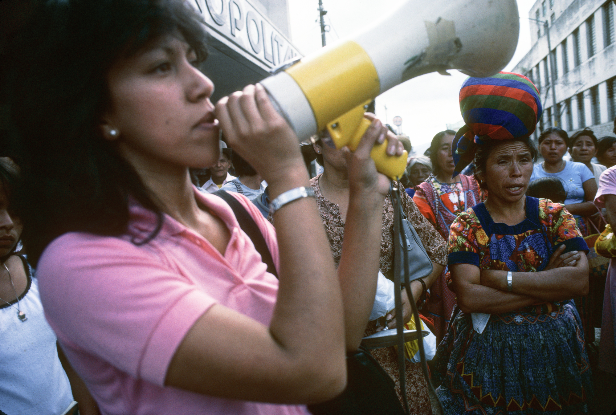 Rosario Godoy de Cuevas speaks into a megaphone at a demonstration at a GAM in Guatemala, 1985.  Grupo de Apoyo Mutuo (GAM; Mutual Support Group) support group for families whose relatives had "disappeared".