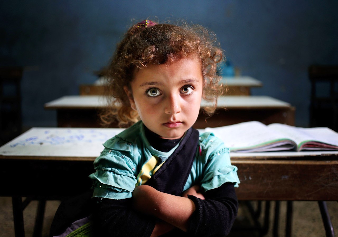 A Syrian refugee girl sits in a classroom at a Lebanese public school where only Syrian students attend classes. Education for refugee children is a pressing global issue that needs long-term solutions. United Nations conventions have fallen short of meeting the needs of displaced populations, even the most vulnerable ones. AP/Hussein Malla, File