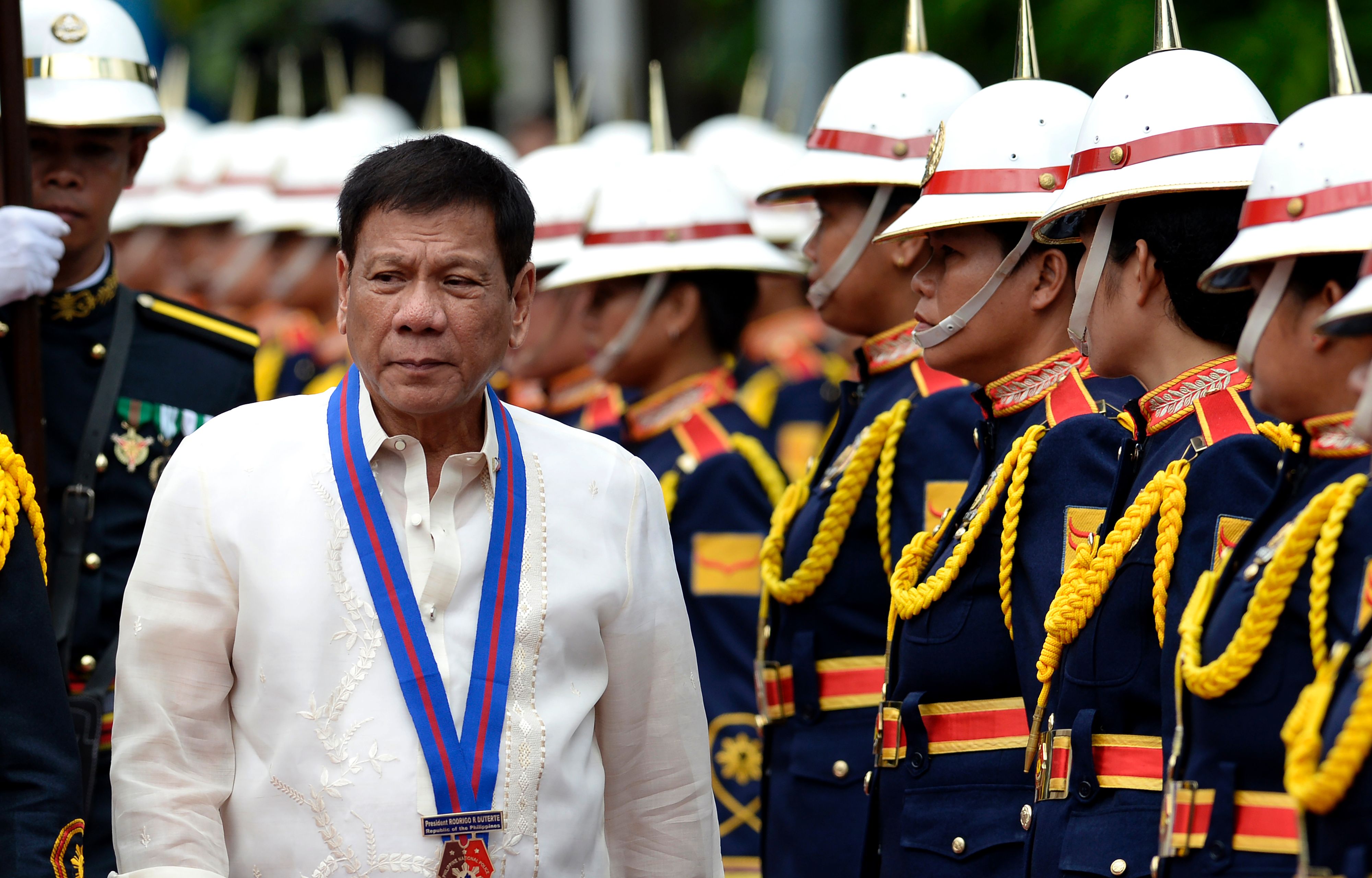 Philippine President Rodrigo Duterte walks past honour guards before Philippine National Police (PNP) chief Ronald Bato Dela Rosa's Assumption of Command Ceremony at the Camp Crame in Manila on July 1, 2016.  Authoritarian firebrand Rodrigo Duterte was sworn in as the Philippines' president on June 30, after promising a ruthless and deeply controversial war on crime would be the main focus of his six-year term. / AFP / NOEL CELIS        (Photo credit should read NOEL CELIS/AFP/Getty Images)